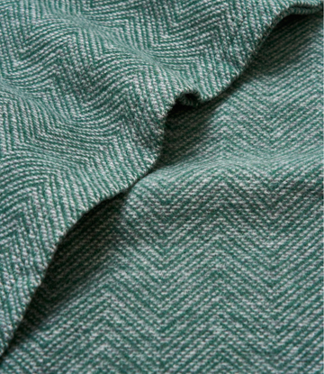 Evergreen woven shawl with herringbone texture pattern and draped folds.7