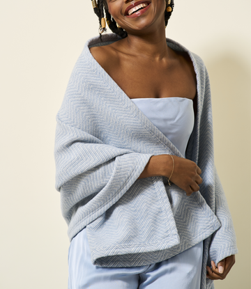 Light gray herringbone patterned shawl draped over shoulders, worn with white strapless top.6