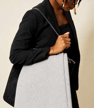 Light grey shawl with herringbone weave pattern worn draped over black blazer.6