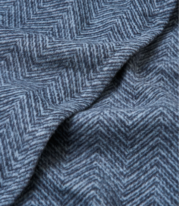 Navy blue shawl with herringbone weave pattern, showing draped fabric texture and fold detail.7
