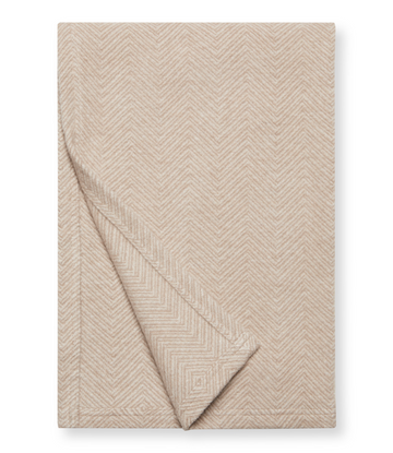 Beige and cream herringbone patterned shawl folded diagonally.5