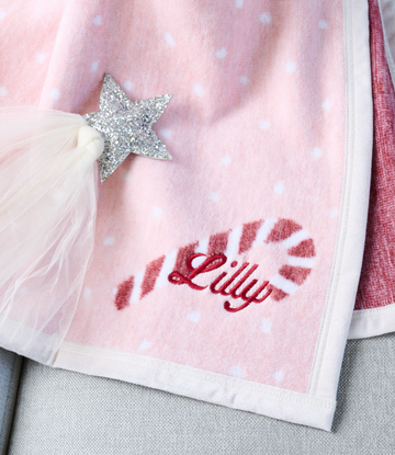 Pink midi blanket with white polka dots, silver glitter star appliqué, tulle trim, and red embroidered text.5