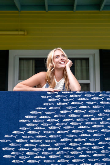 Navy blanket with white fish pattern draped over a railing.2