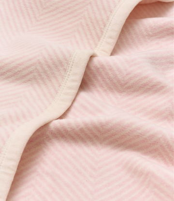 Ballet pink herringbone blanket with cream binding detail, close-up of texture and weave pattern.5