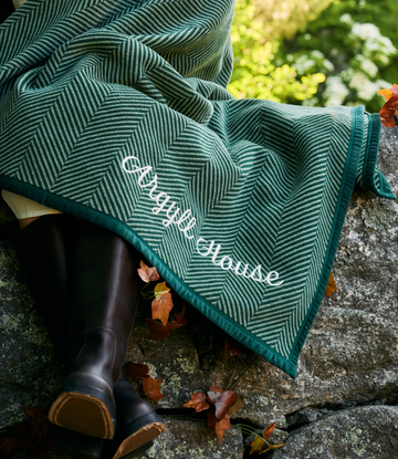 Forest green midi blanket with herringbone pattern and "Harborview" text embroidered on edge.6