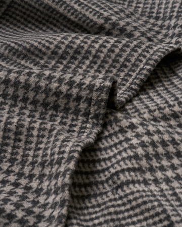 Gray and charcoal plaid woven shawl with draped folds showing textured fabric detail.7