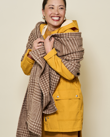 Brown and tan plaid shawl draped over woman's shoulders worn with yellow jacket.3