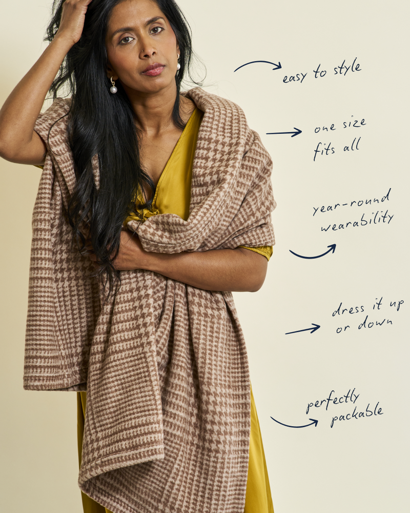 Chocolate brown and cream plaid shawl draped over woman's shoulders with yellow top underneath.