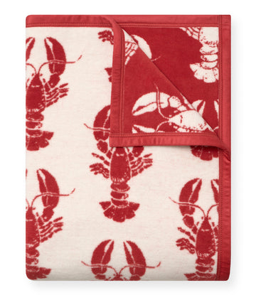 Red and cream blanket with repeated lobster pattern throughout and red binding edges.6
