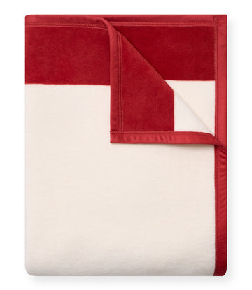 Red and cream striped blanket with red binding edges, shown partially folded.8