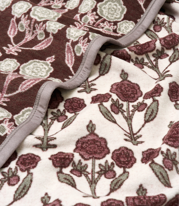 Folded blanket with blockprint pattern featuring burgundy and cream berries with green leaves on dark and light backgrounds, 5