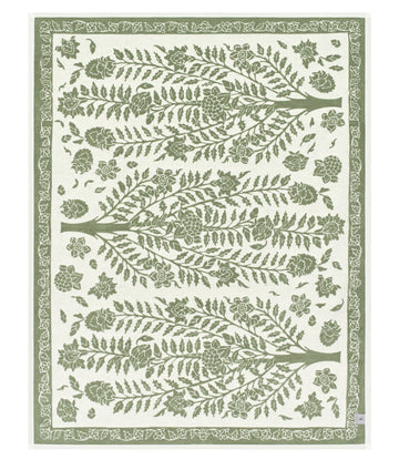Green and cream blanket with tree branches, leaves, and floral motifs throughout, bordered with decorative leaf pattern.7
