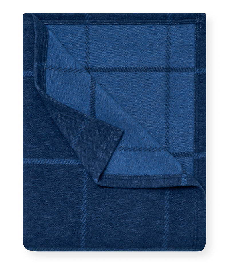 Navy blue lightweight blanket with windowpane plaid pattern, shown partially folded.
