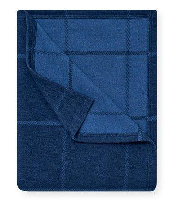 Navy blue lightweight blanket with windowpane plaid pattern, shown partially folded.1